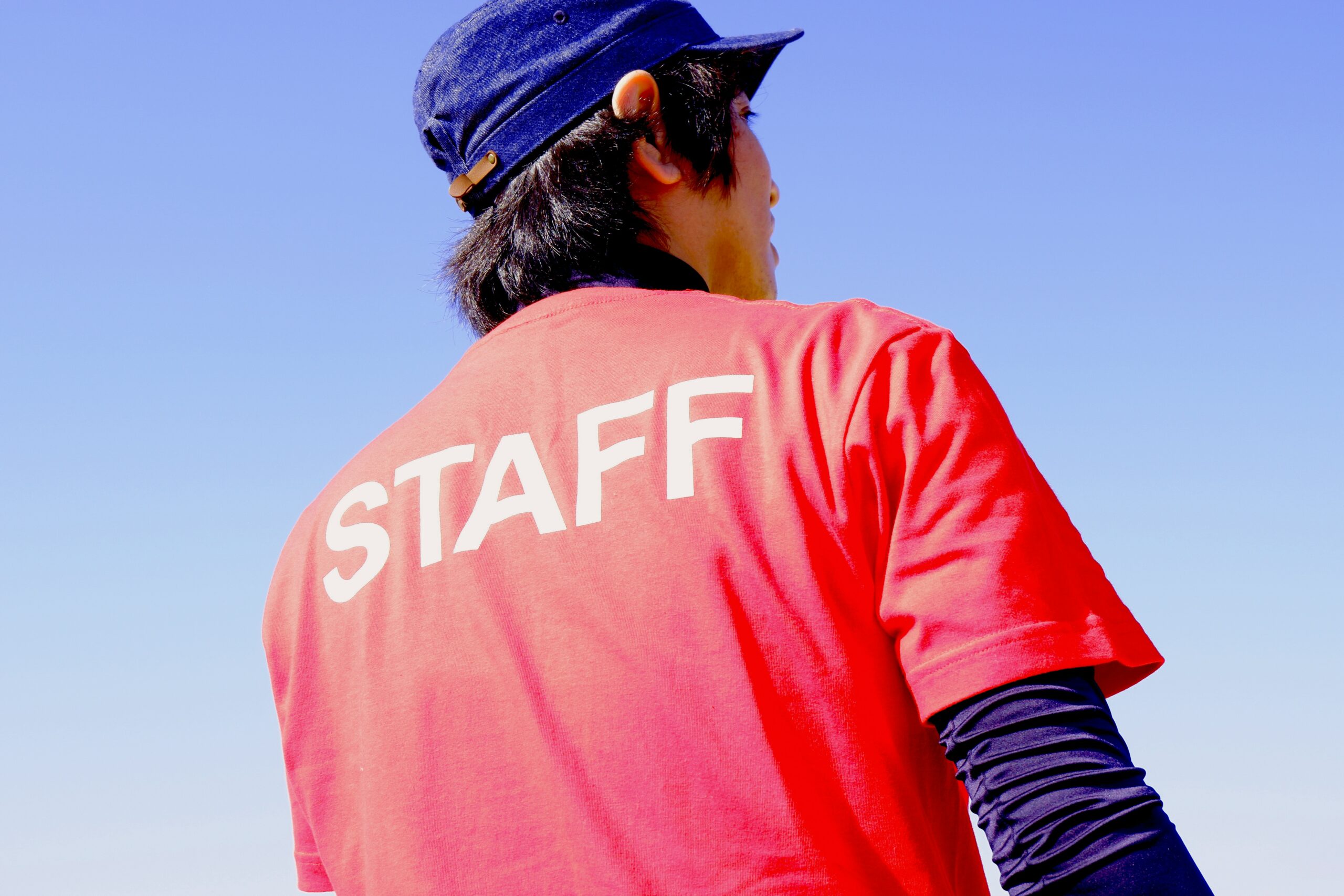 Man wearing a red Staff shirt